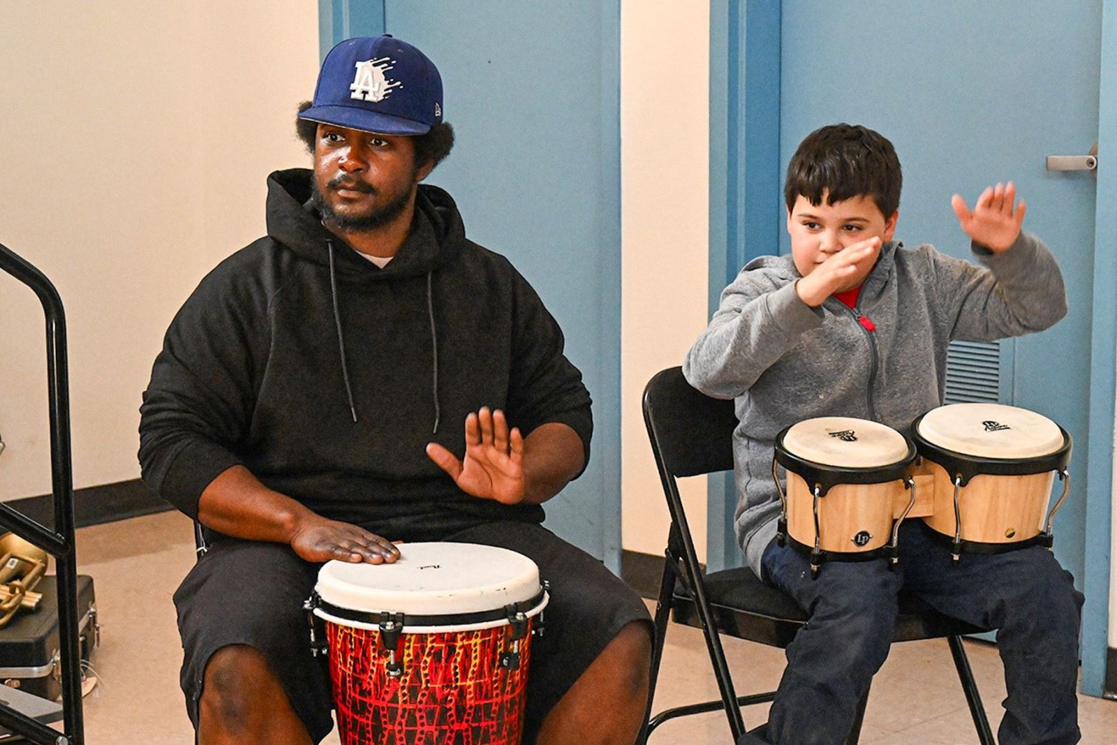 Two students play the drums.