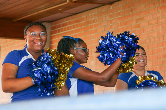 Cheer squad smiles while performing.
